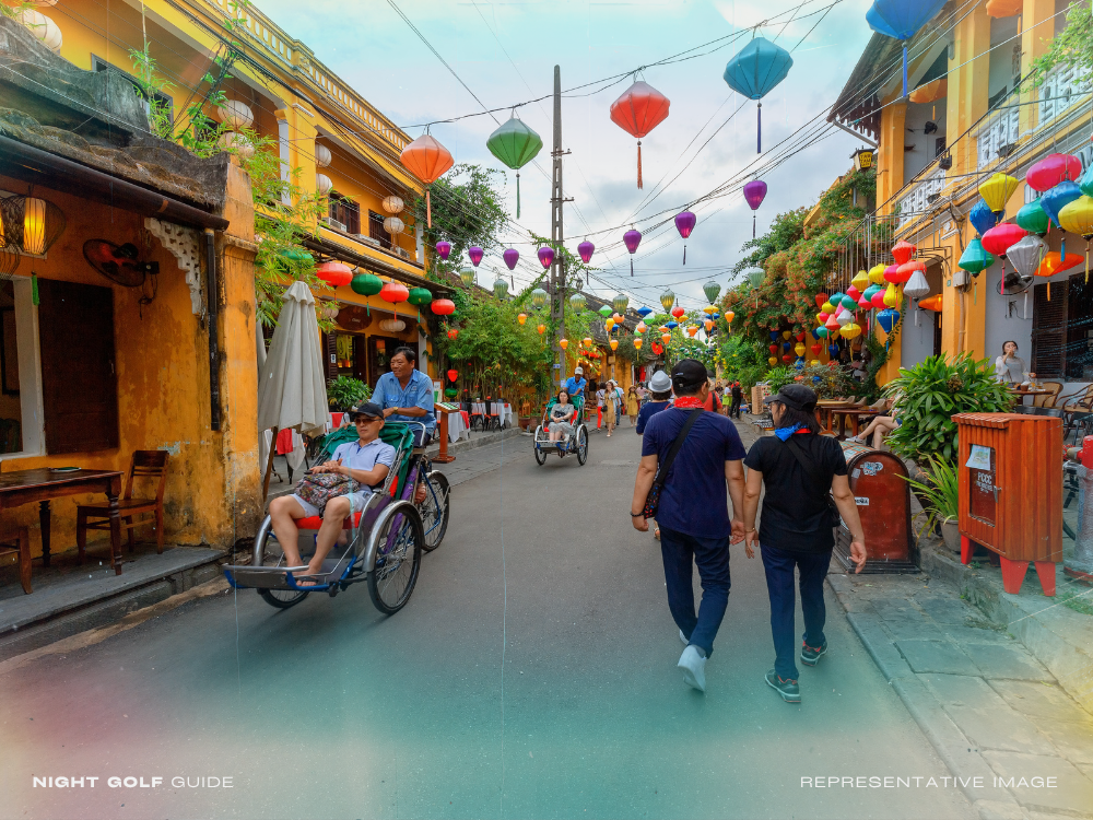 Night golf location near shopping street with LED lighting and city nightlife