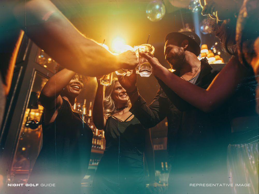 Friends toasting cocktails after a night golf match
