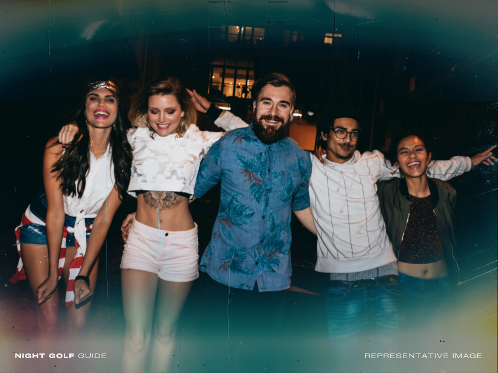 Friends celebrating and partying after night golf with drinks and laughter