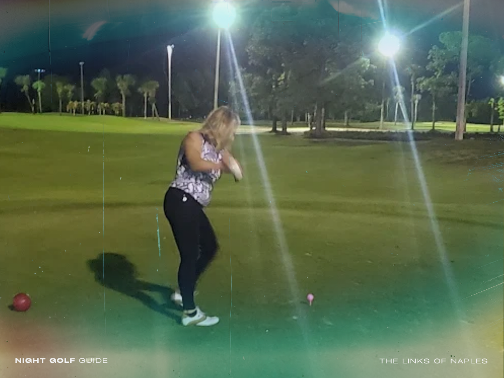 Golfers playing under lights at The Links of Naples with vibrant course lighting and evening sky backdrop